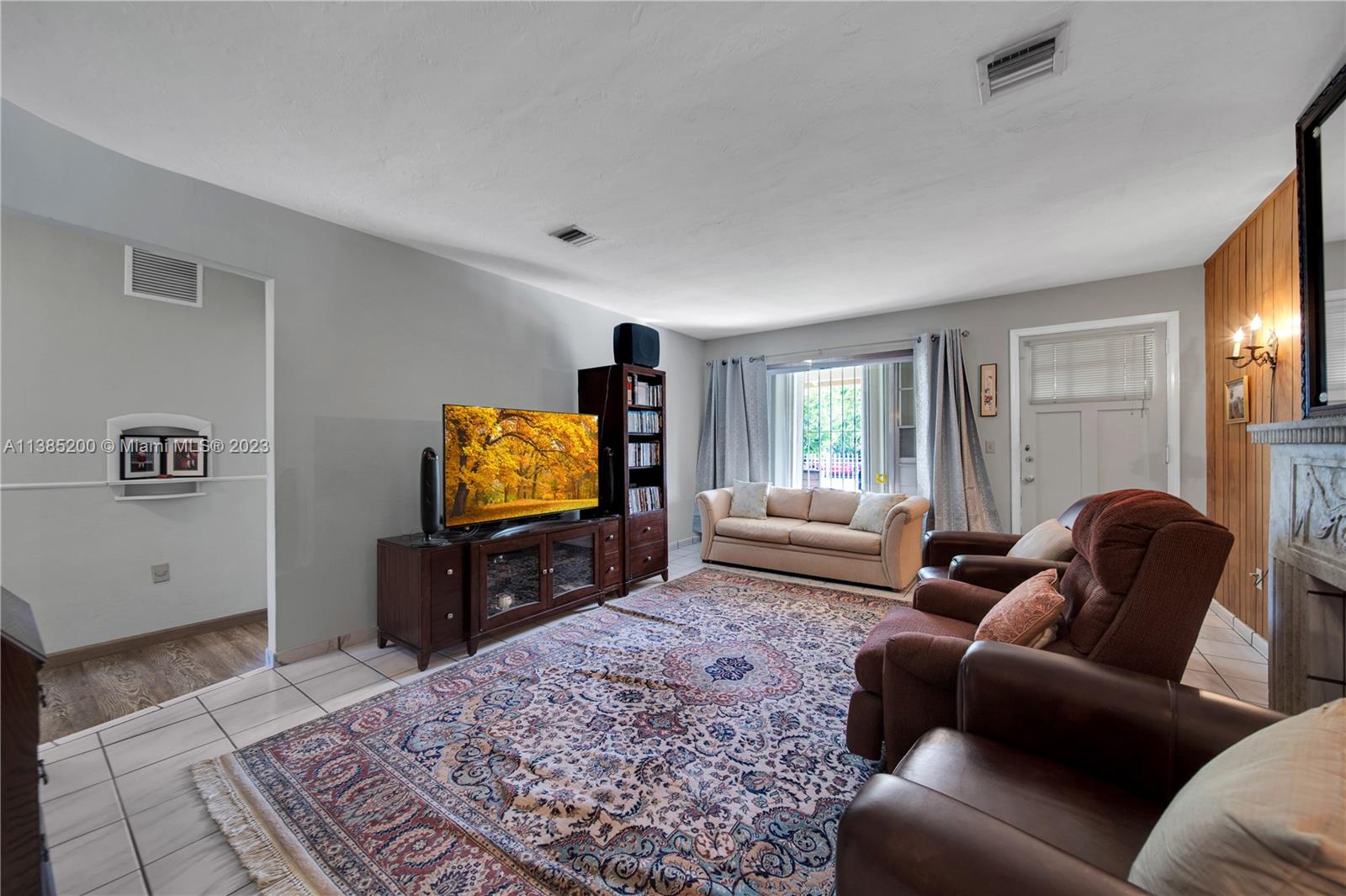 615 Southwest 21st Road Miami, FL 33129 - Photo 23 of 43 a living room with furniture and a flat screen tv