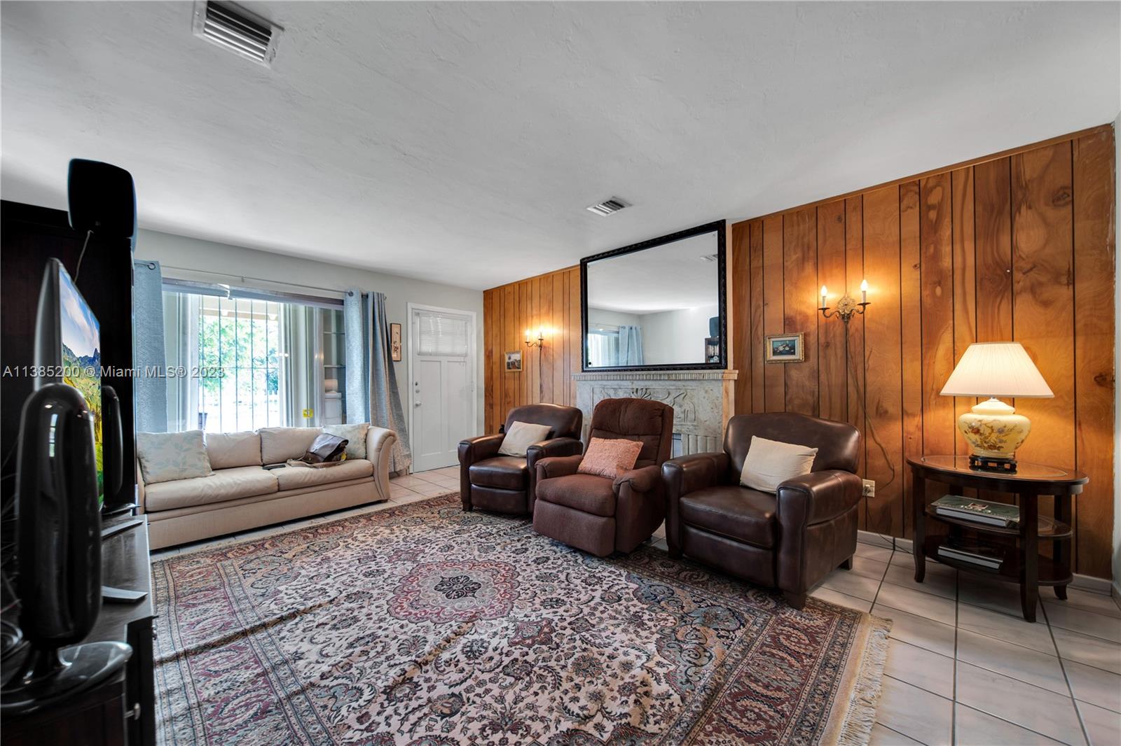 615 Southwest 21st Road Miami, FL 33129 - Photo 5 of 43 a living room with furniture and a fireplace