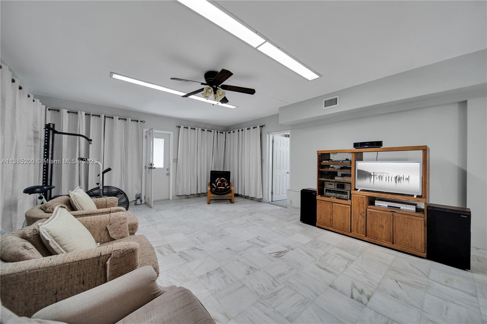615 Southwest 21st Road Miami, FL 33129 - Photo 6 of 43 a view of a livingroom with furniture and a ceiling fan