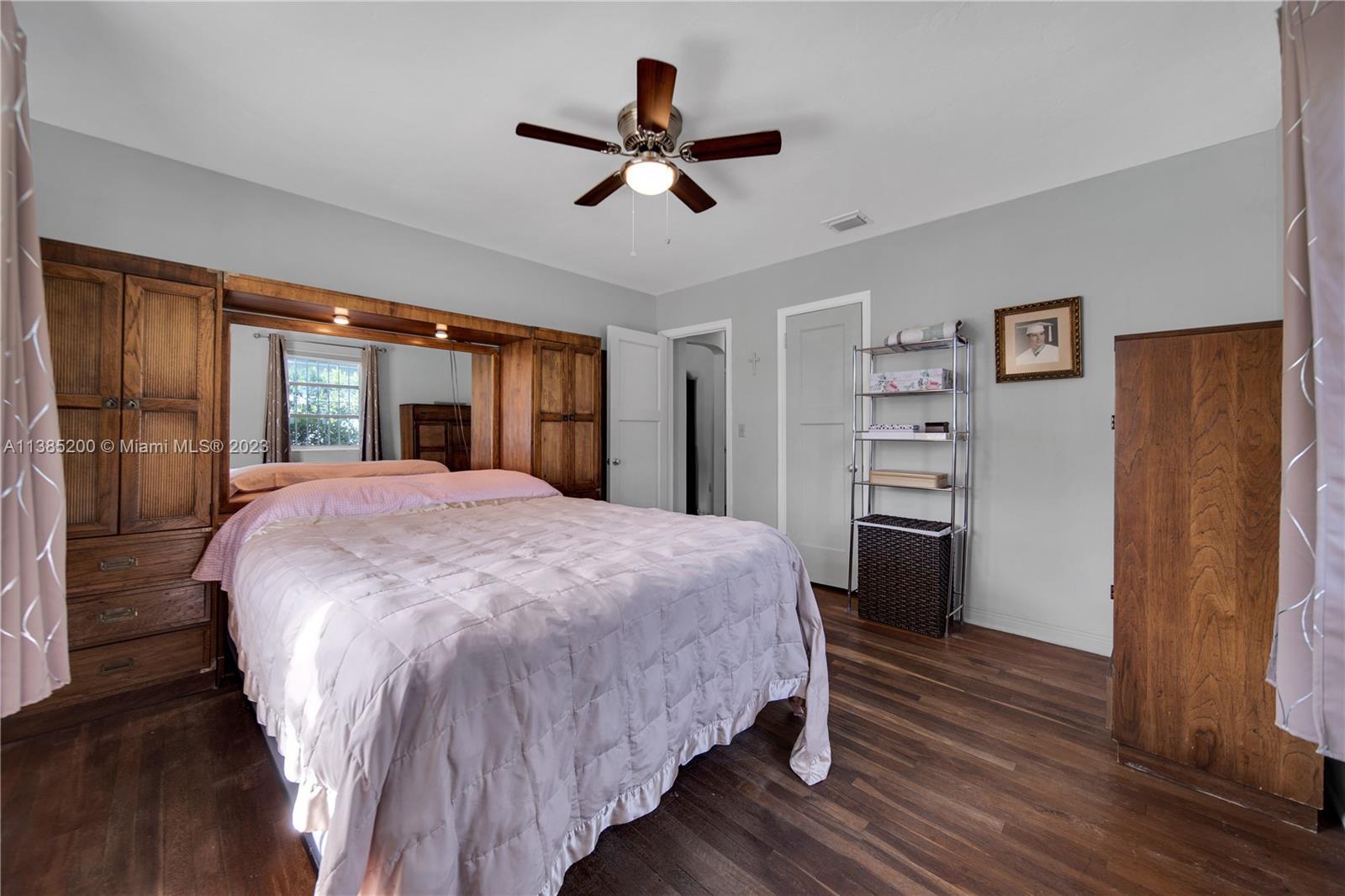 615 Southwest 21st Road Miami, FL 33129 - Photo 8 of 43 a spacious bedroom with a bed and a large mirror