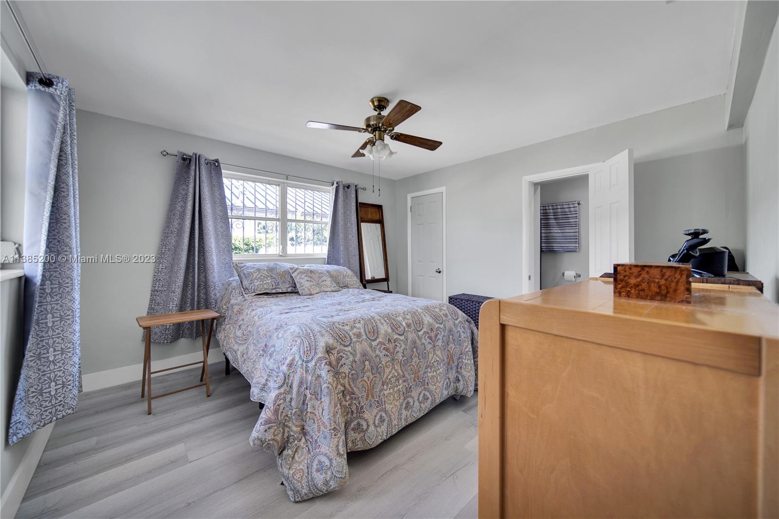 615 Southwest 21st Road Miami, FL 33129 - Photo 10 of 43 a bed room with a bed and a chandelier