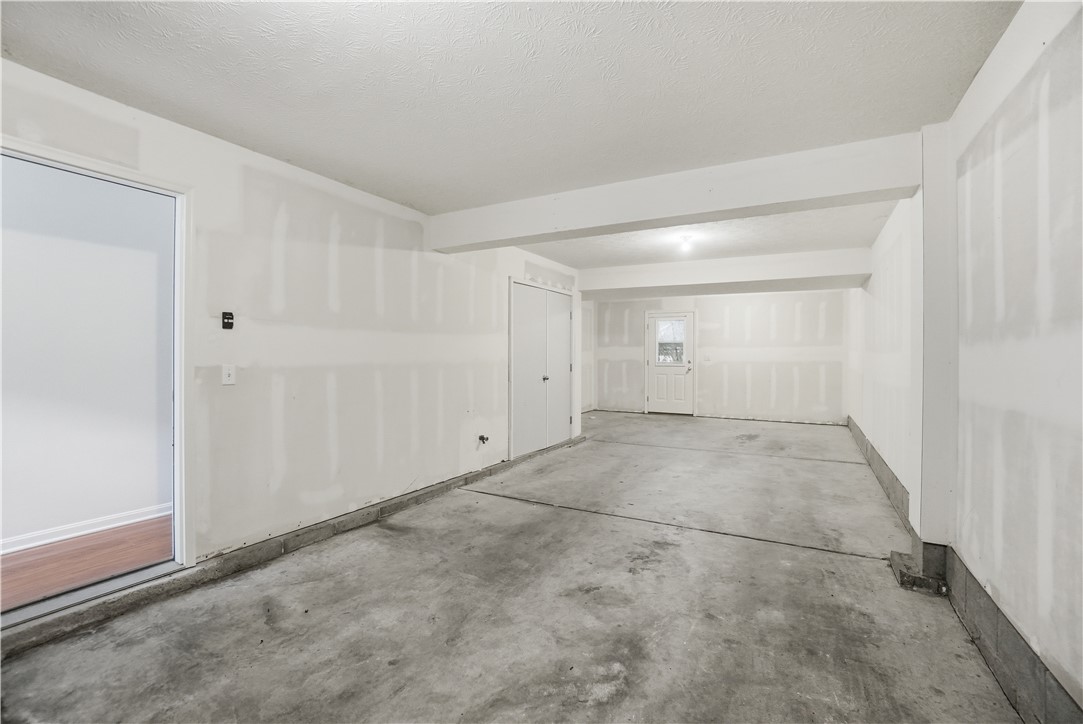 4294 Straight Arrow Road Dayton, OH 45430 - Photo 36 of 41 This spacious garage offers ample room for vehicles and storage, featuring durable concrete flooring.