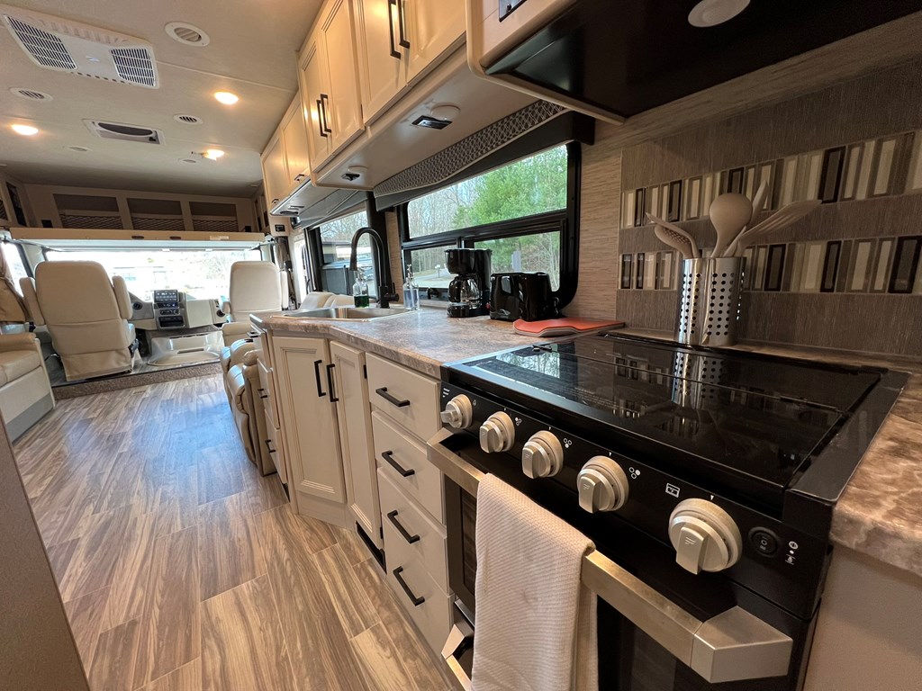 62 Waterside Blue Ridge Morganton, GA 30560 - Photo 16 of 38 a kitchen with stainless steel appliances granite countertop a stove a sink dishwasher and cabinets with wooden floor