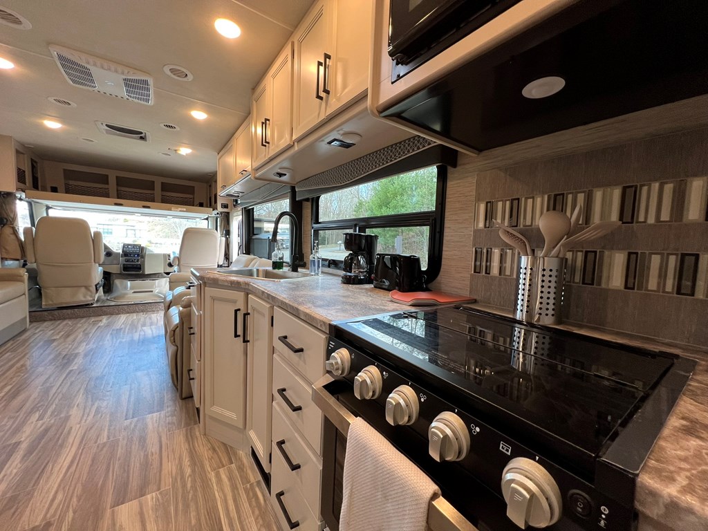 62 Waterside Blue Ridge Morganton, GA 30560 - Photo 17 of 38 a kitchen with stainless steel appliances granite countertop a sink a stove and a wooden floors
