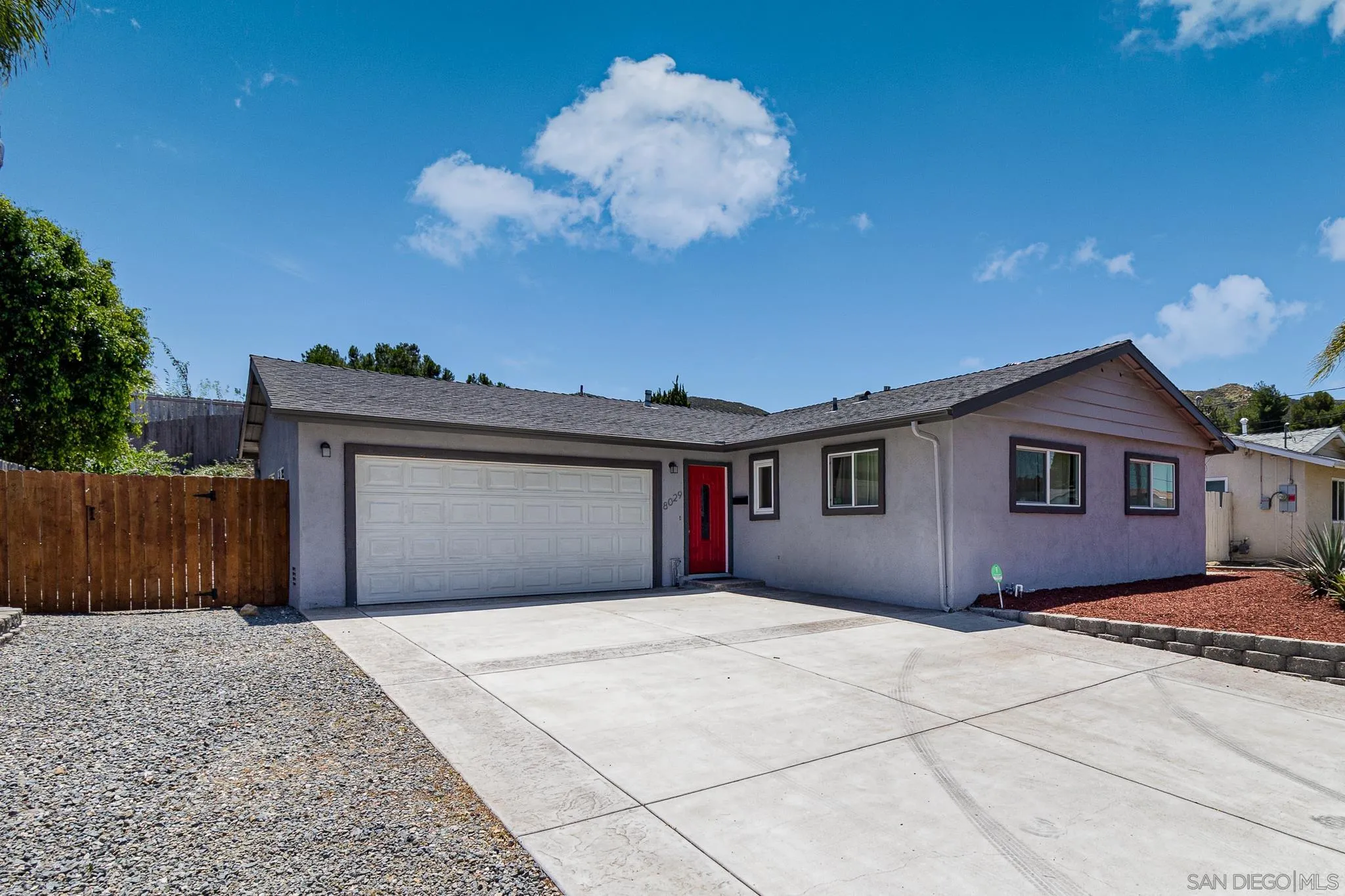 8029 Woodpecker Way Santee, CA 92071 - Photo 1 of 47 a front view of a house with a garage