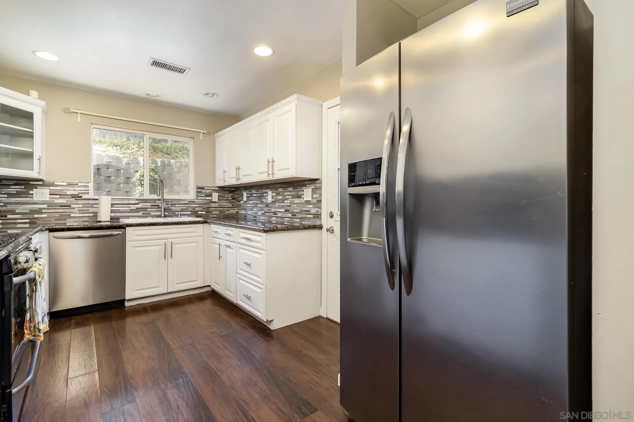 8029 Woodpecker Way Santee, CA 92071 - Photo 12 of 47 a kitchen with stainless steel appliances a refrigerator sink and cabinets