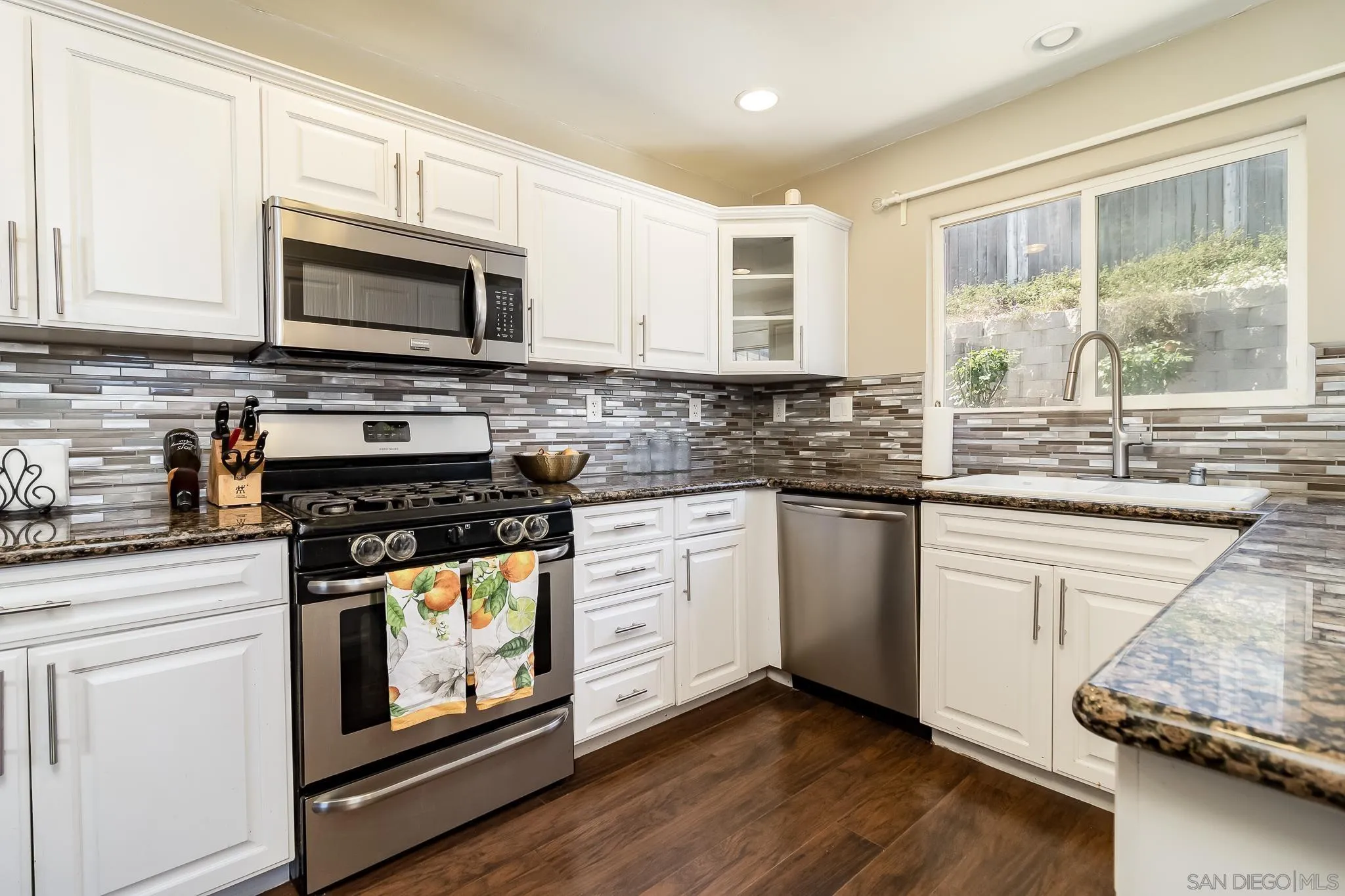 8029 Woodpecker Way Santee, CA 92071 - Photo 13 of 47 a kitchen with stainless steel appliances white cabinets granite counter tops and a window