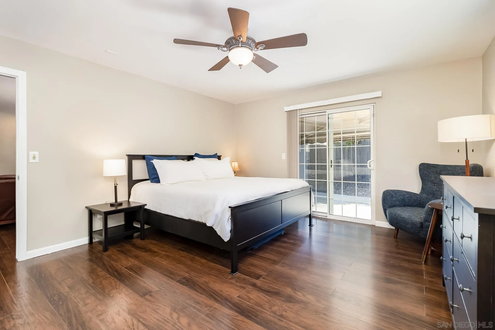 8029 Woodpecker Way Santee, CA 92071 - Photo 16 of 47 a bedroom with a bed and wooden floor