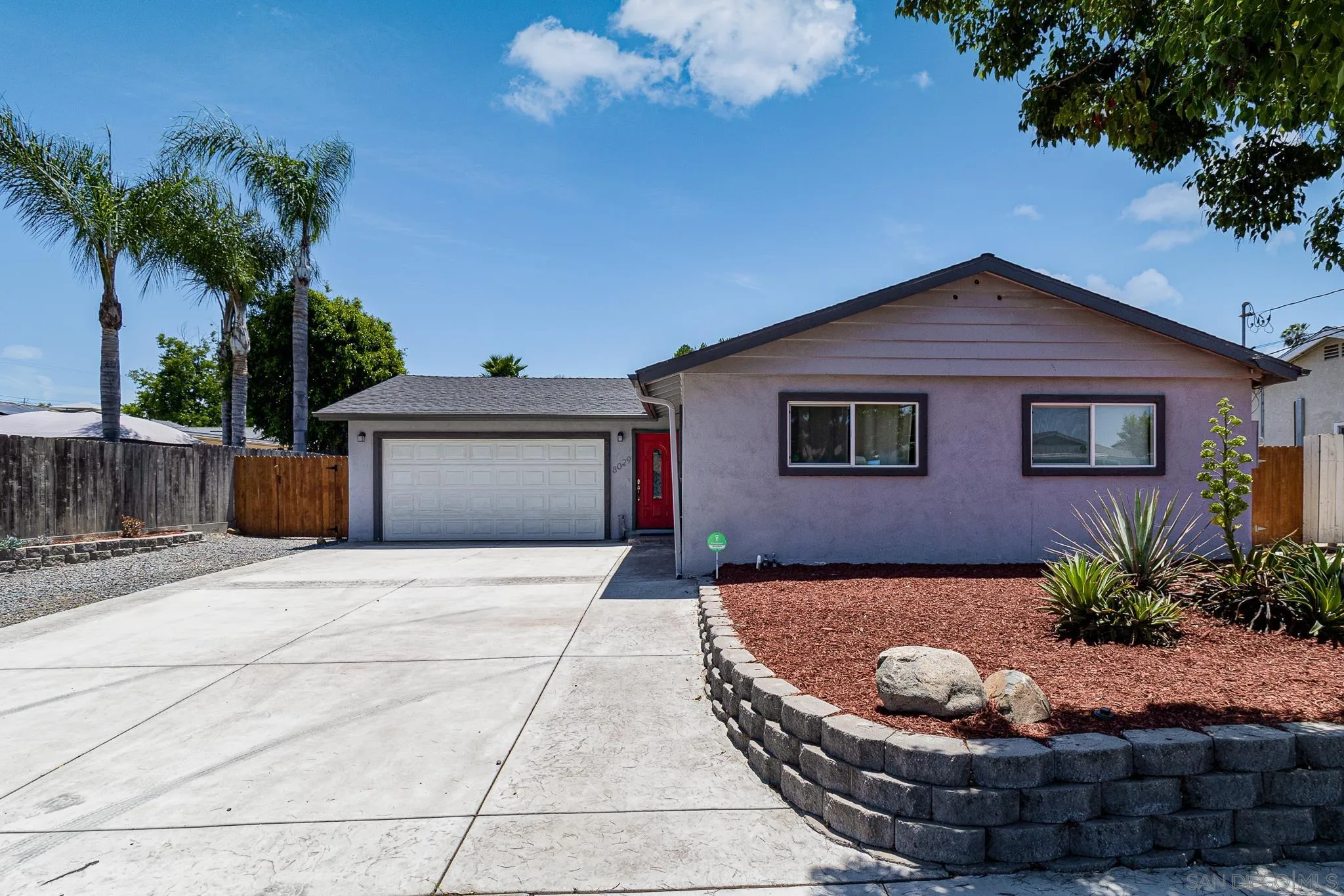 8029 Woodpecker Way Santee, CA 92071 - Photo 2 of 47 a view of a house with a flower garden