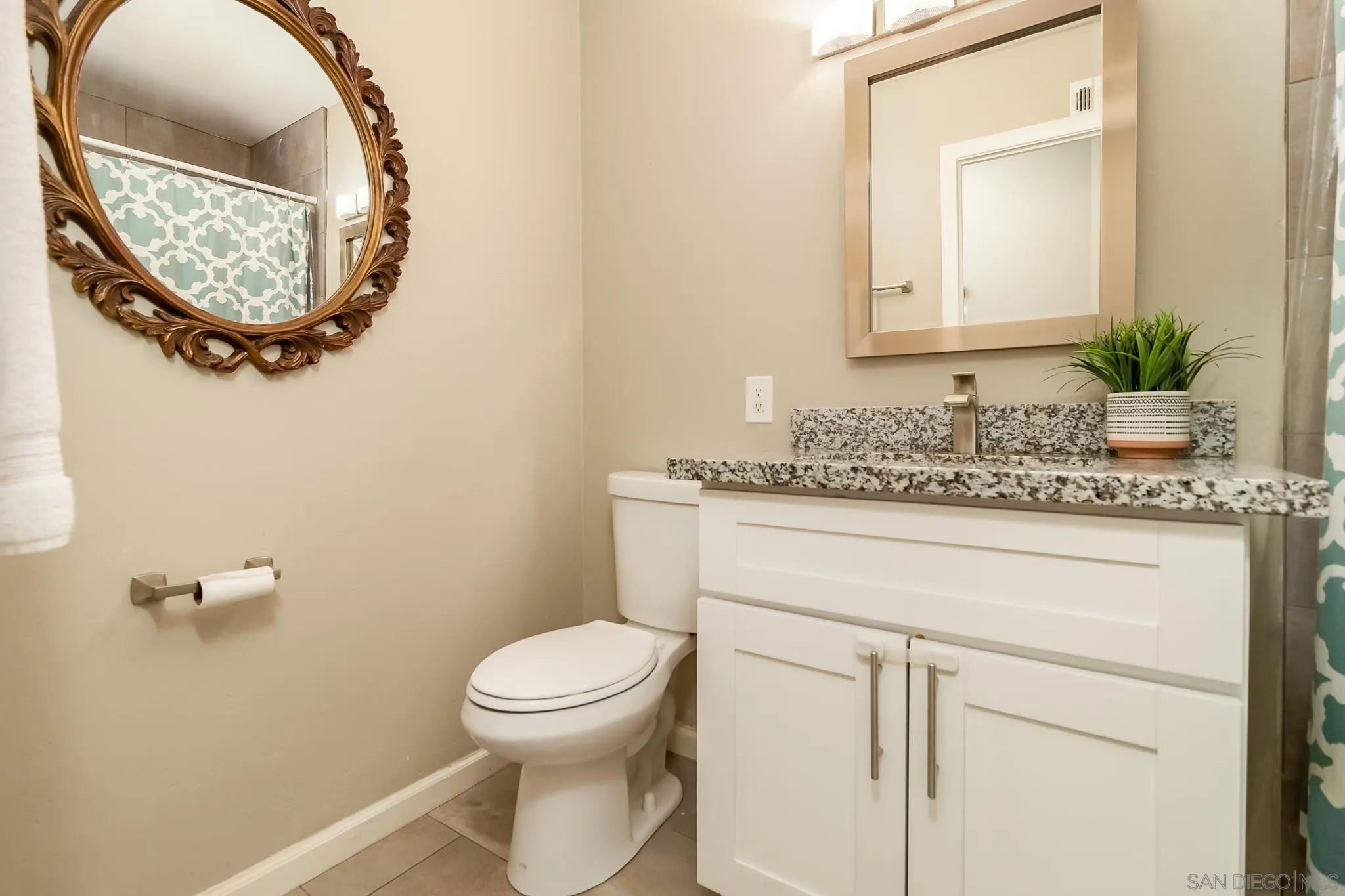 8029 Woodpecker Way Santee, CA 92071 - Photo 21 of 47 a bathroom with a granite countertop toilet sink and mirror