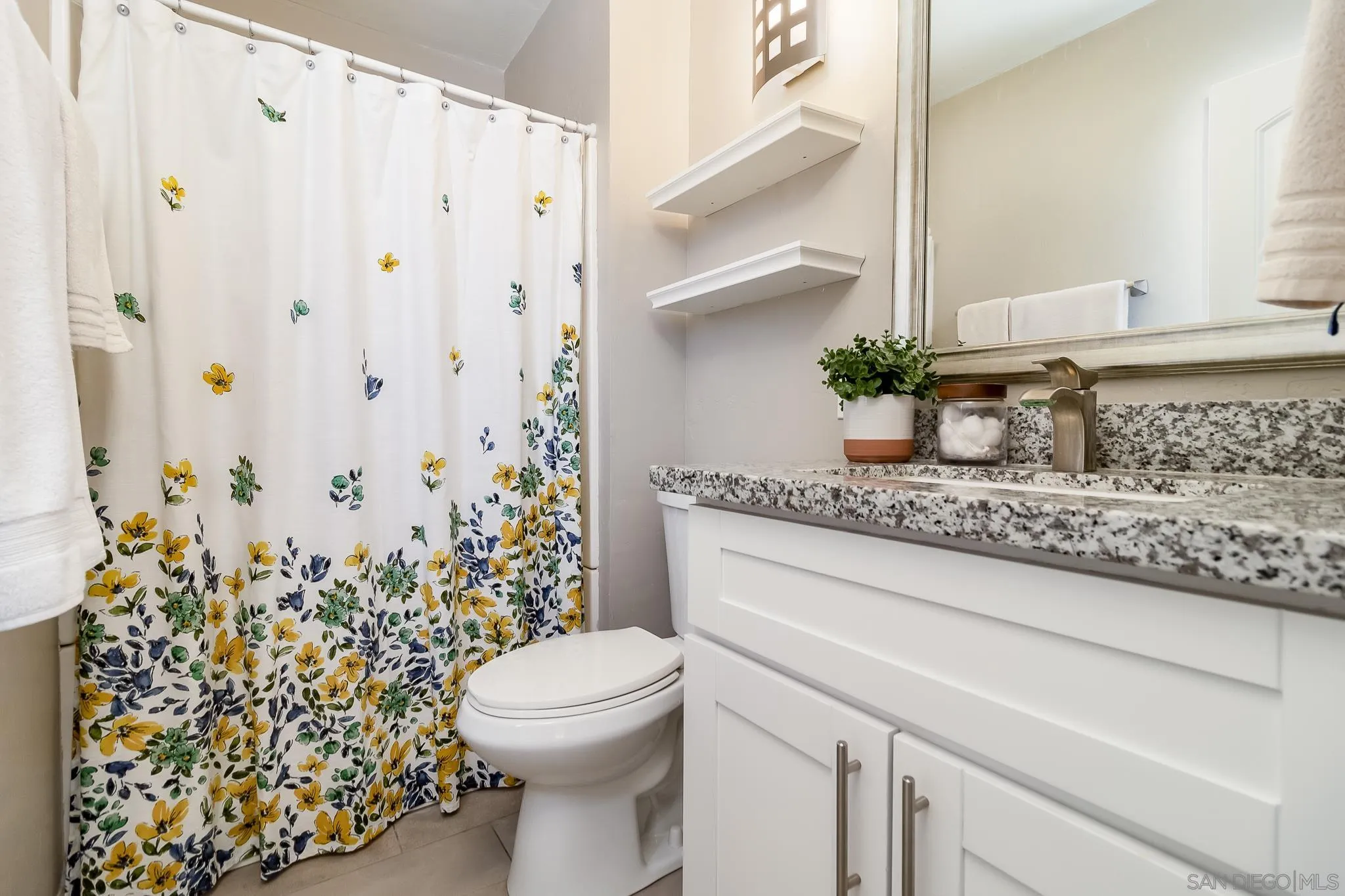 8029 Woodpecker Way Santee, CA 92071 - Photo 24 of 47 a bathroom with a granite countertop sink a toilet and a mirror