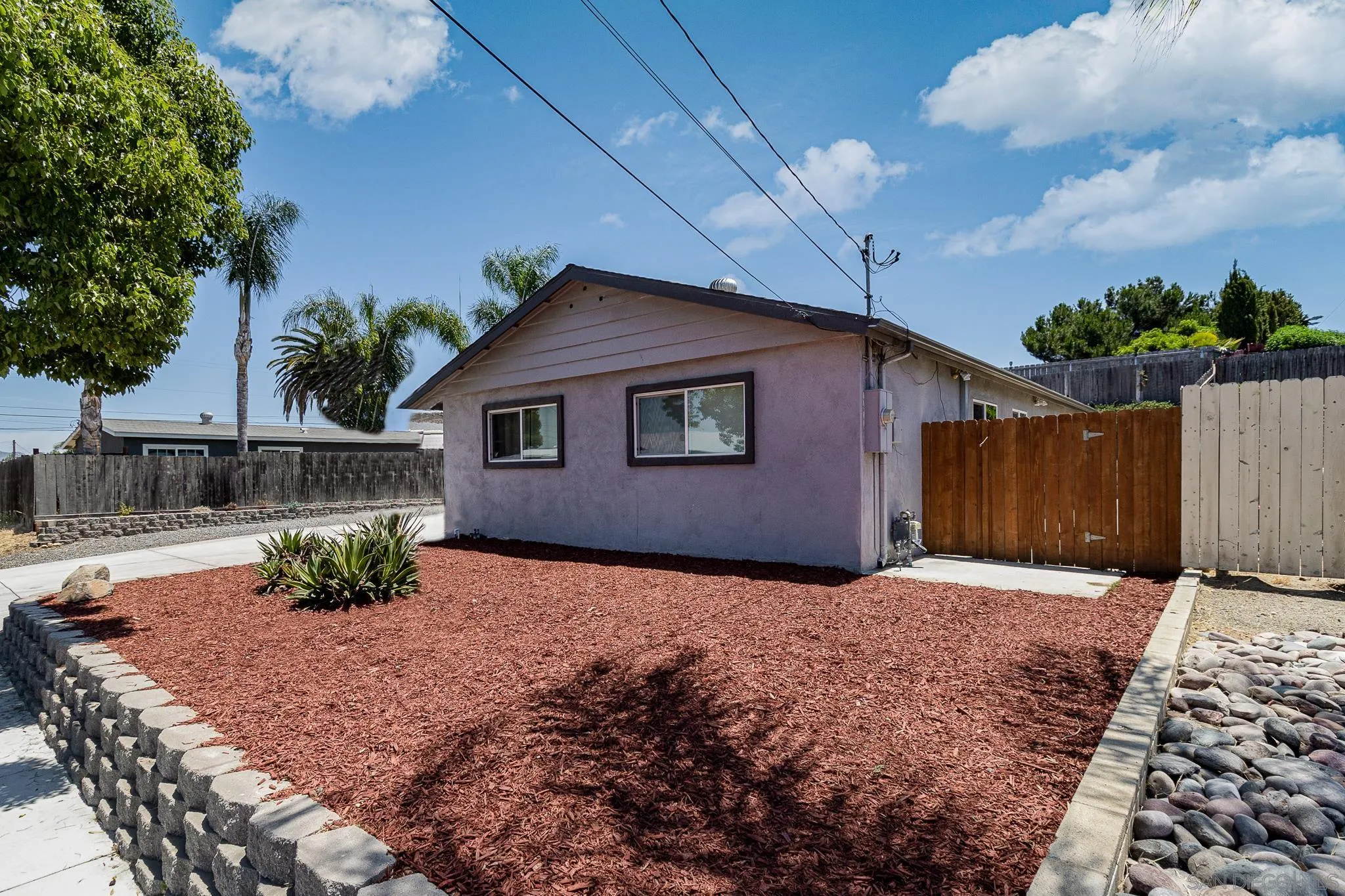 8029 Woodpecker Way Santee, CA 92071 - Photo 3 of 47 a backyard of a house with table and chairs