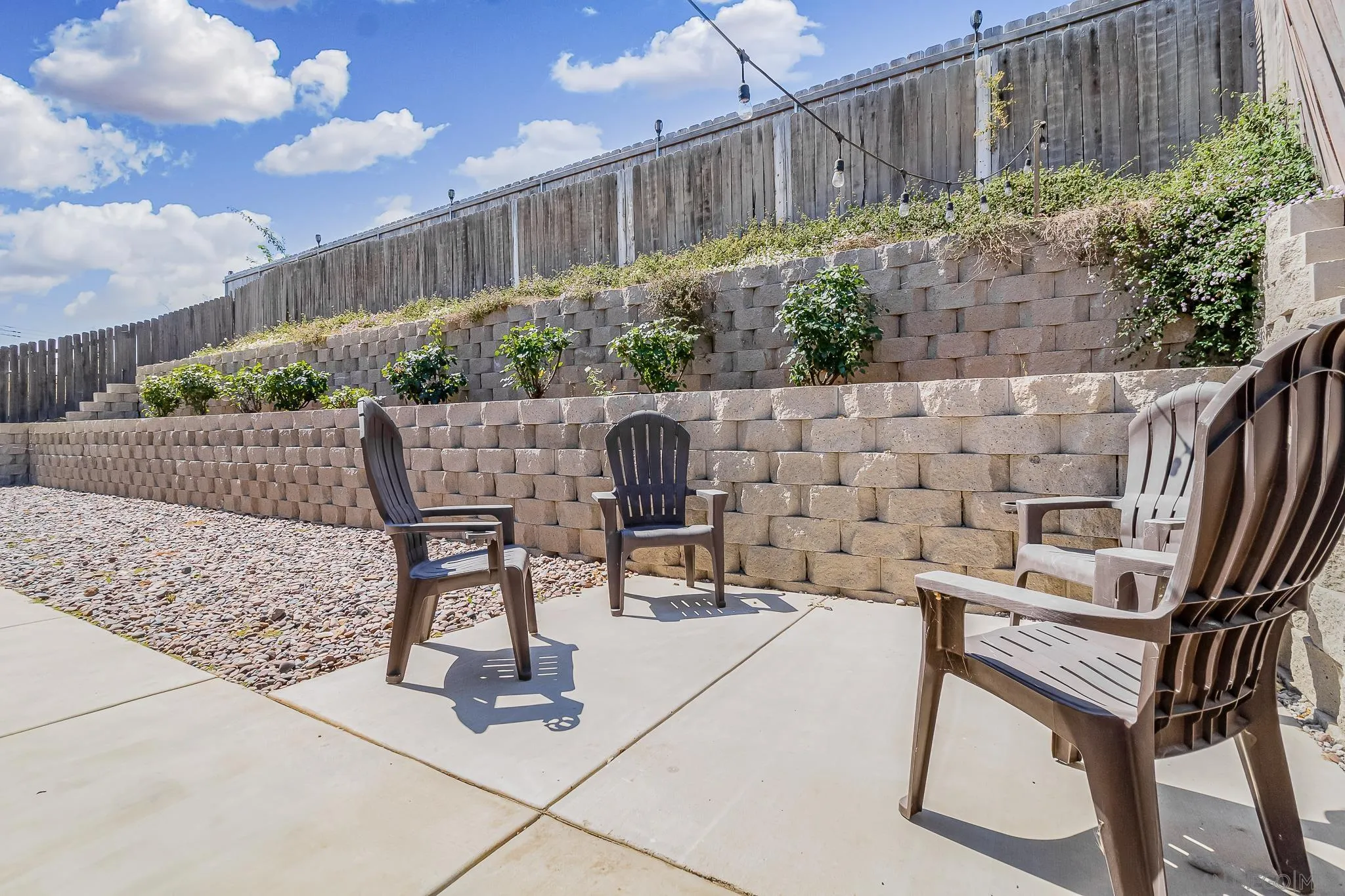8029 Woodpecker Way Santee, CA 92071 - Photo 32 of 47 a view of patio with table and chairs and potted plants