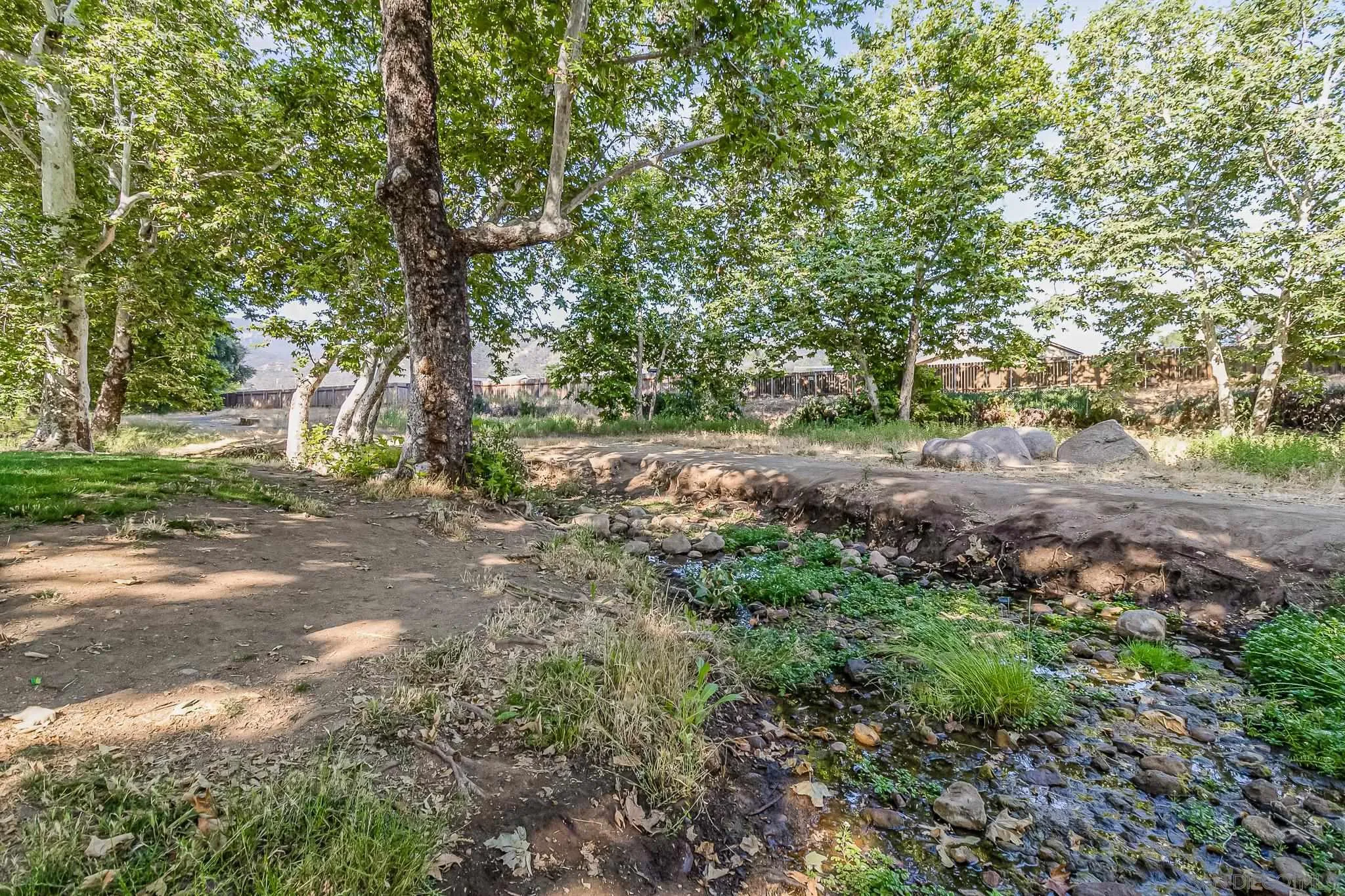 8029 Woodpecker Way Santee, CA 92071 - Photo 42 of 47 a backyard of a house with lots of green space