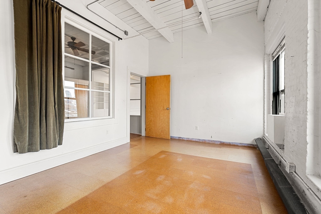249 A Street, Unit 66 Boston, MA 02210 - Photo 19 of 26 a view of an empty room with a window