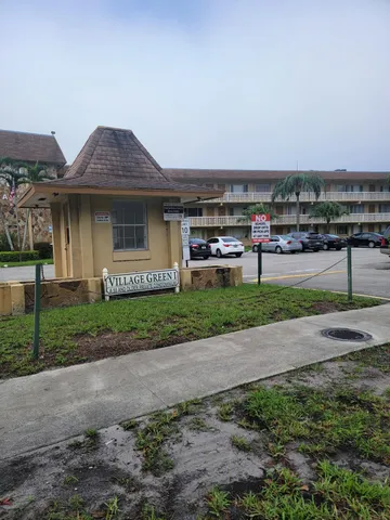 a front view of a house with a garden and yard