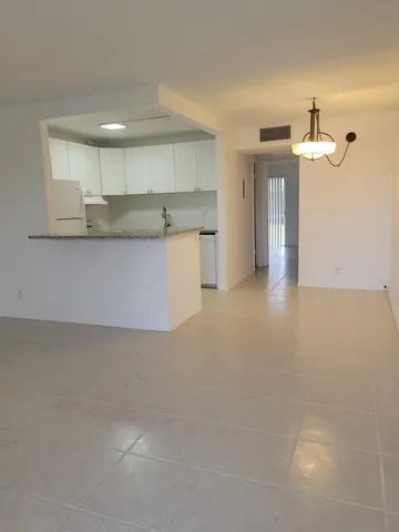 a view of kitchen and kitchen with granite countertop