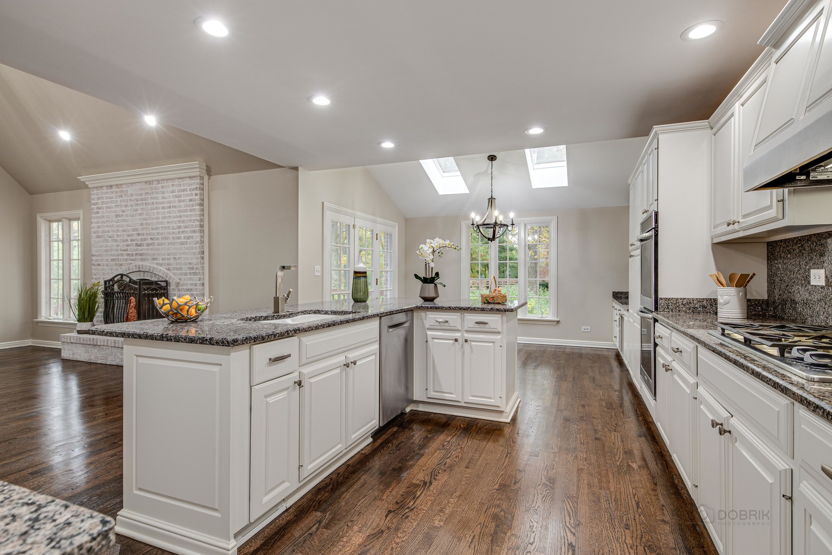 875 Valley Road Lake Forest, IL 60045 - Photo 14 of 43 a large kitchen with stainless steel appliances lots of counter space and wooden floor
