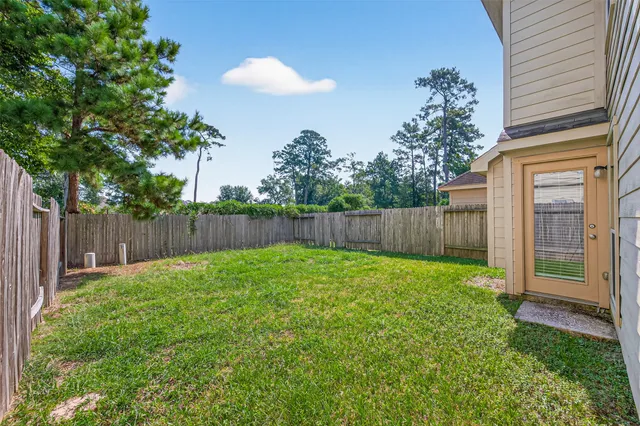 a view of a backyard with a trees and flower plants