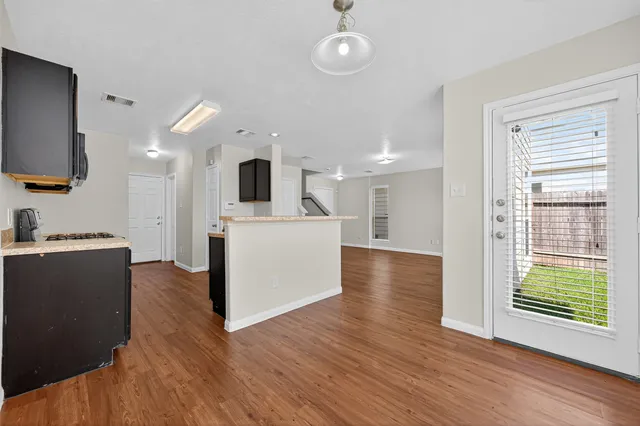 a view of a kitchen cabinets and wooden floor