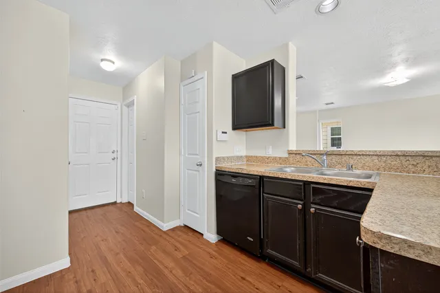 a spacious bathroom with a granite countertop sink and a mirror