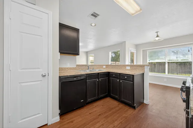 a spacious bathroom with a granite countertop sink and a large mirror