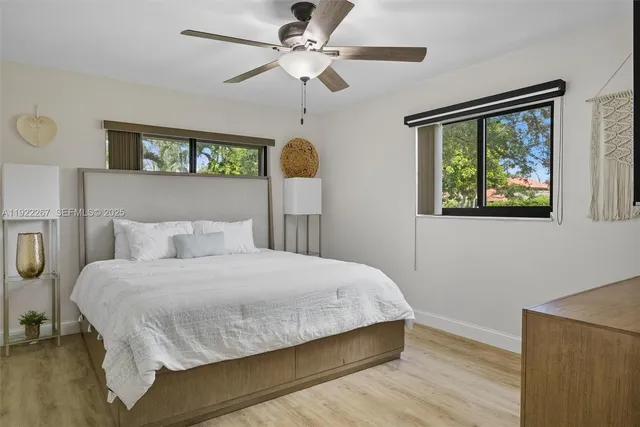 a bedroom with a large bed chandelier and a window