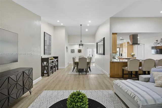 a living room with furniture and a wooden floor