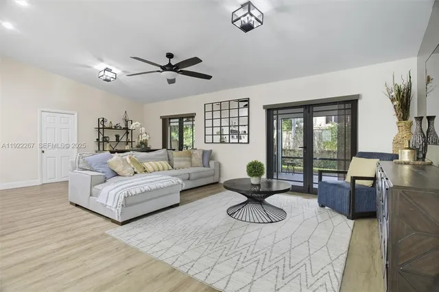 a living room with furniture ceiling fan and a window