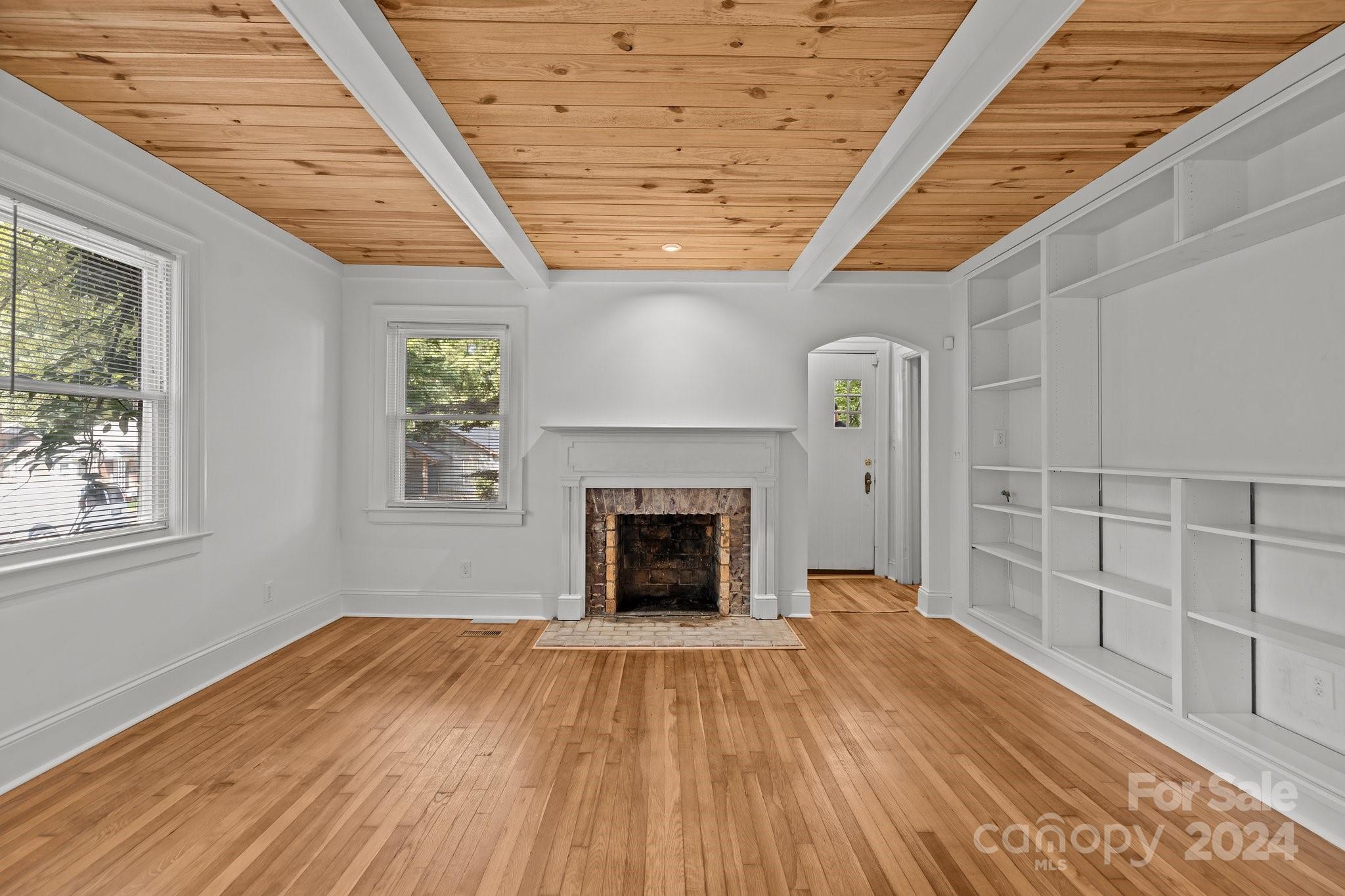 3020 Rush Avenue Charlotte, NC 28208 - Photo 15 of 31 a view of empty room with wooden floor and fireplace