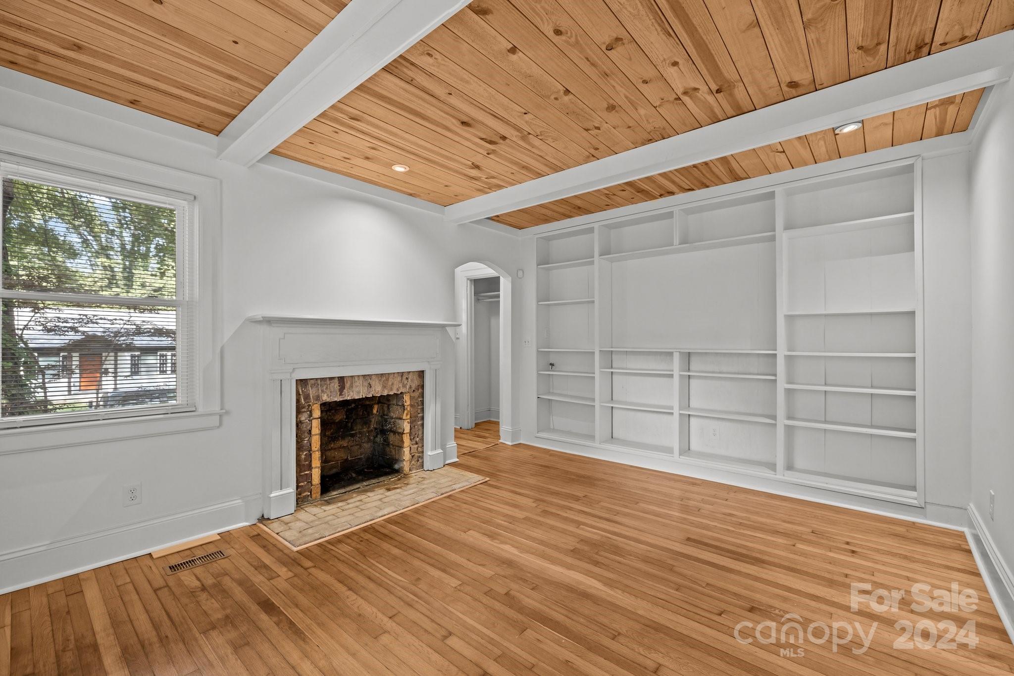 3020 Rush Avenue Charlotte, NC 28208 - Photo 18 of 31 a view of an empty room with a fireplace and a window