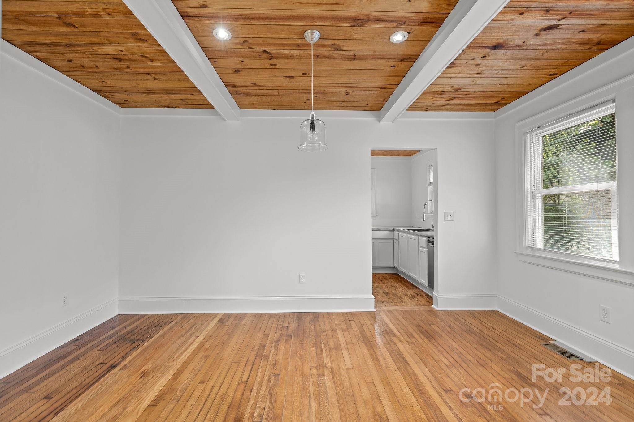3020 Rush Avenue Charlotte, NC 28208 - Photo 21 of 31 an empty room with wooden floor and windows