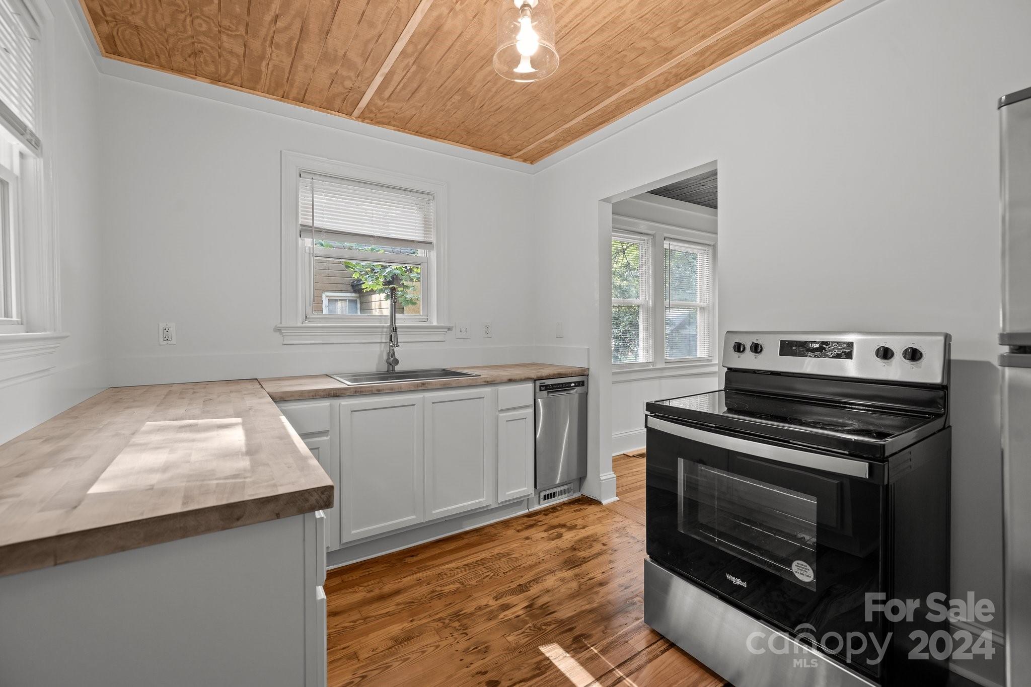 3020 Rush Avenue Charlotte, NC 28208 - Photo 5 of 31 a kitchen with a stove a sink and a microwave