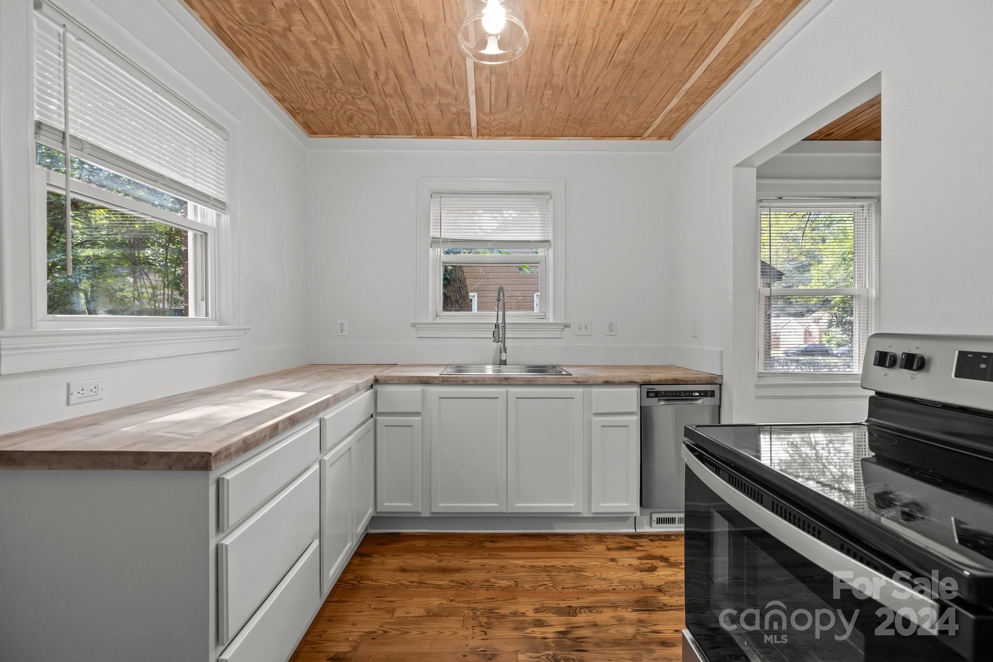 3020 Rush Avenue Charlotte, NC 28208 - Photo 6 of 31 a kitchen with a sink stove and cabinets
