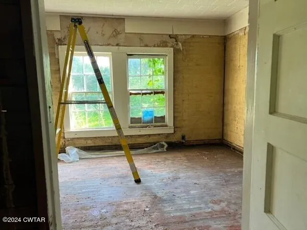a view of an empty room with a window