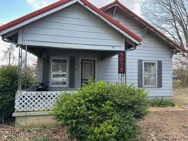 a front view of a house with a small yard