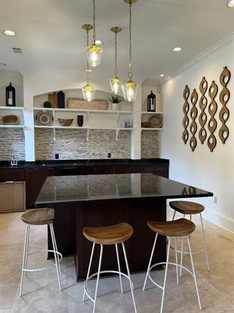 a kitchen with a dining table chairs and white cabinets