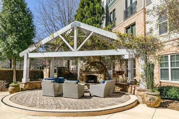 a view of a house with backyard fountain and sitting area