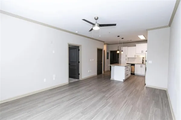 a view of a kitchen with wooden floor and a kitchen