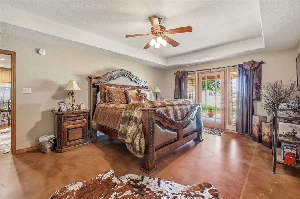 2548 Fm 1496 Dublin, TX 76446 - Photo 13 of 40 a bedroom with a bed and a chandelier