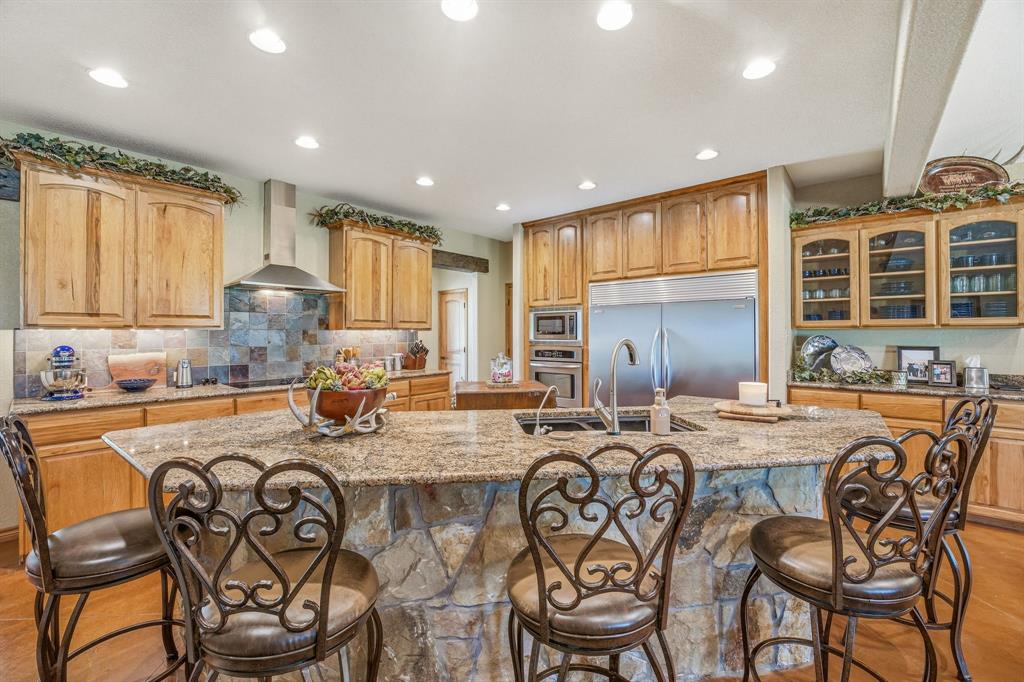 2548 Fm 1496 Dublin, TX 76446 - Photo 8 of 40 a kitchen with stainless steel appliances granite countertop a table chairs sink refrigerator and cabinets