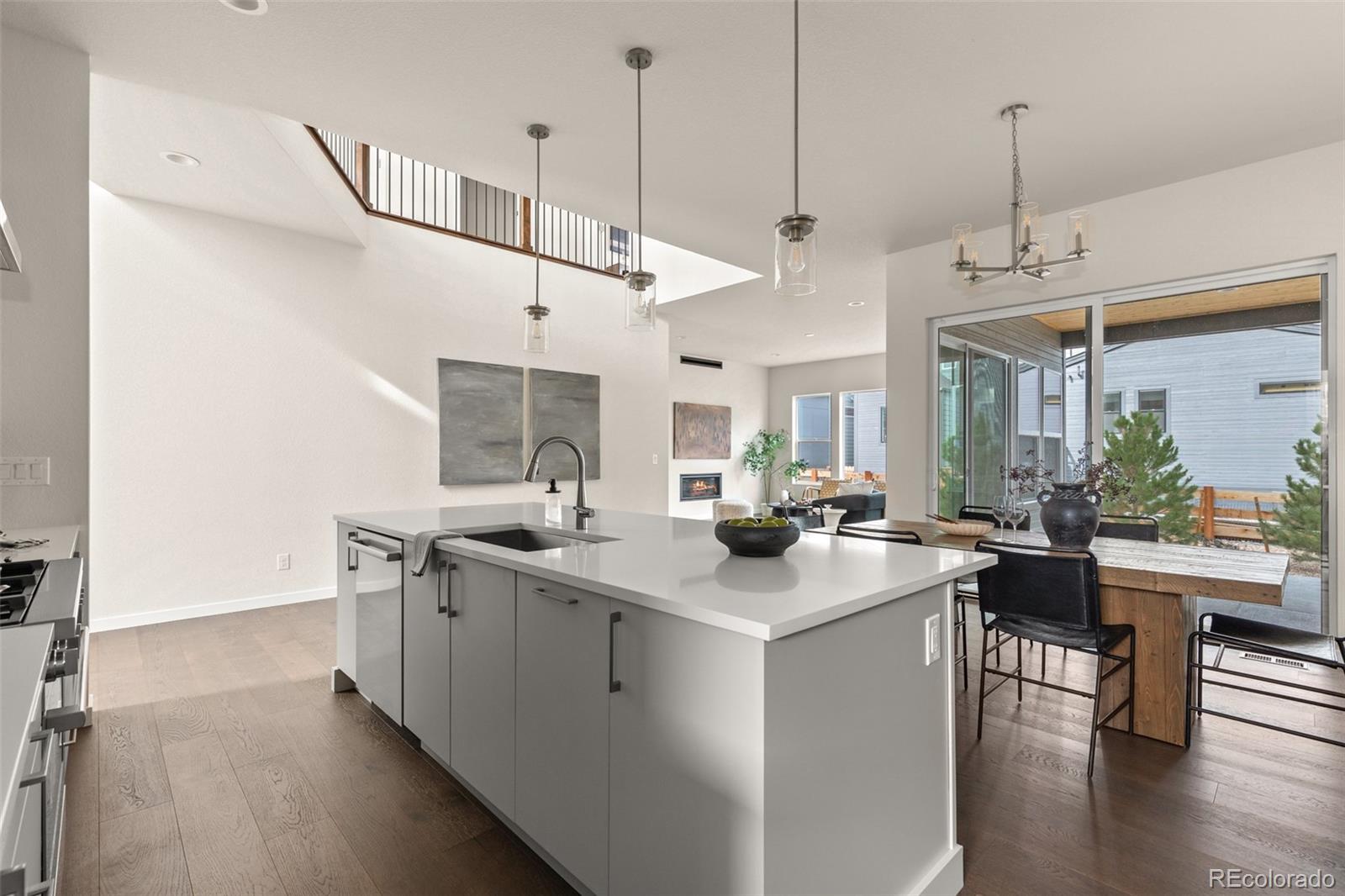 11332 Alla Breve Lone Tree, CO 80134 - Photo 11 of 50 a kitchen with stainless steel appliances granite countertop a sink a stove and a wooden floors