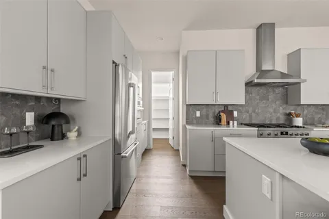 a kitchen with a sink a stove and cabinets