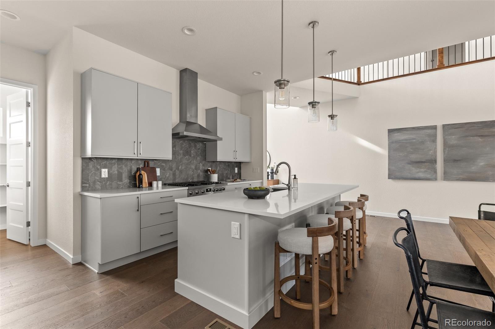 11332 Alla Breve Lone Tree, CO 80134 - Photo 13 of 50 a kitchen that has a sink a table and chairs in it