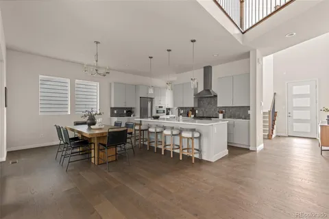 a open dining room with kitchen island furniture a chandelier stainless steel appliances and cabinets