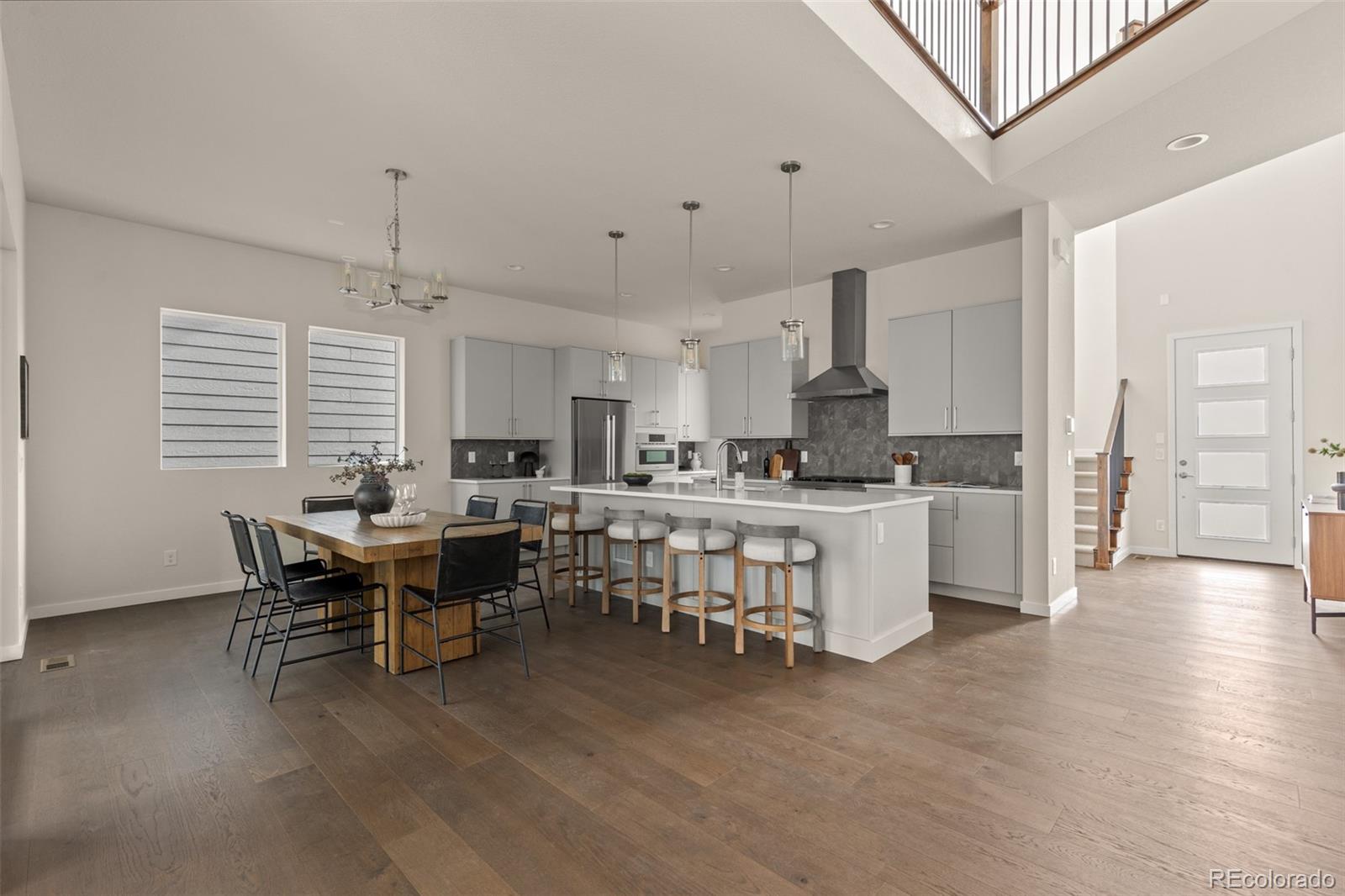 11332 Alla Breve Lone Tree, CO 80134 - Photo 17 of 50 a open dining room with kitchen island furniture a chandelier stainless steel appliances and cabinets