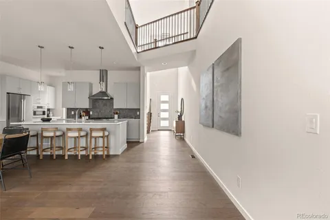 a large white kitchen with lots of counter space a sink and appliances