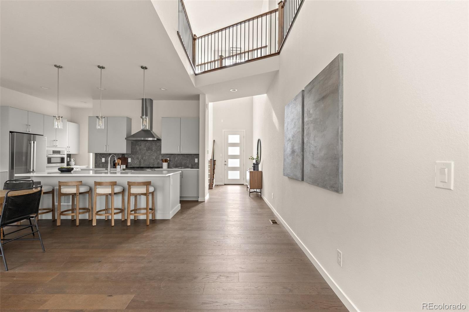 11332 Alla Breve Lone Tree, CO 80134 - Photo 18 of 50 a large white kitchen with lots of counter space a sink and appliances