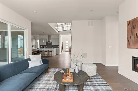 a living room with furniture and a dining table