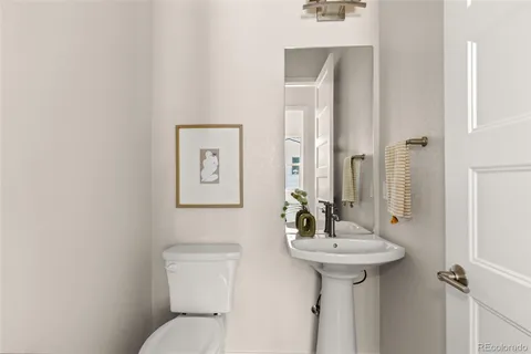 a bathroom with a sink toilet and a mirror